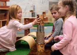 Montessori teacher reading a story to a group of attentive children in a peaceful environment.